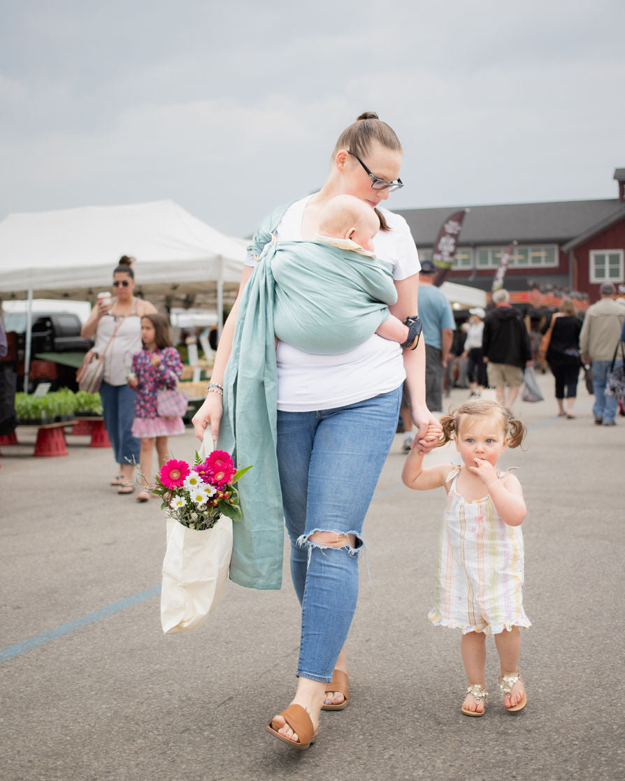 Wear your baby hands free so you can hold your toddler's hand!