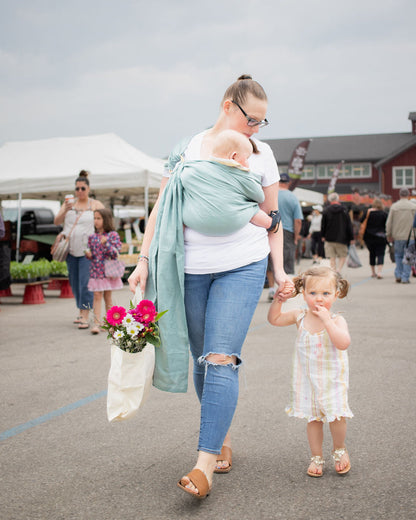 Wear your baby hands free so you can hold your toddler's hand!