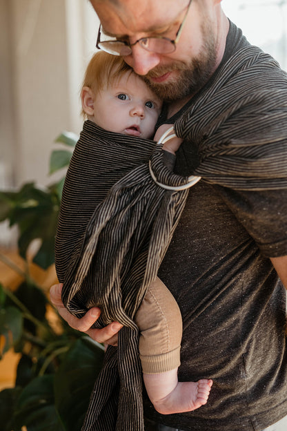 babywearing dad in black stripe ring sling carrier