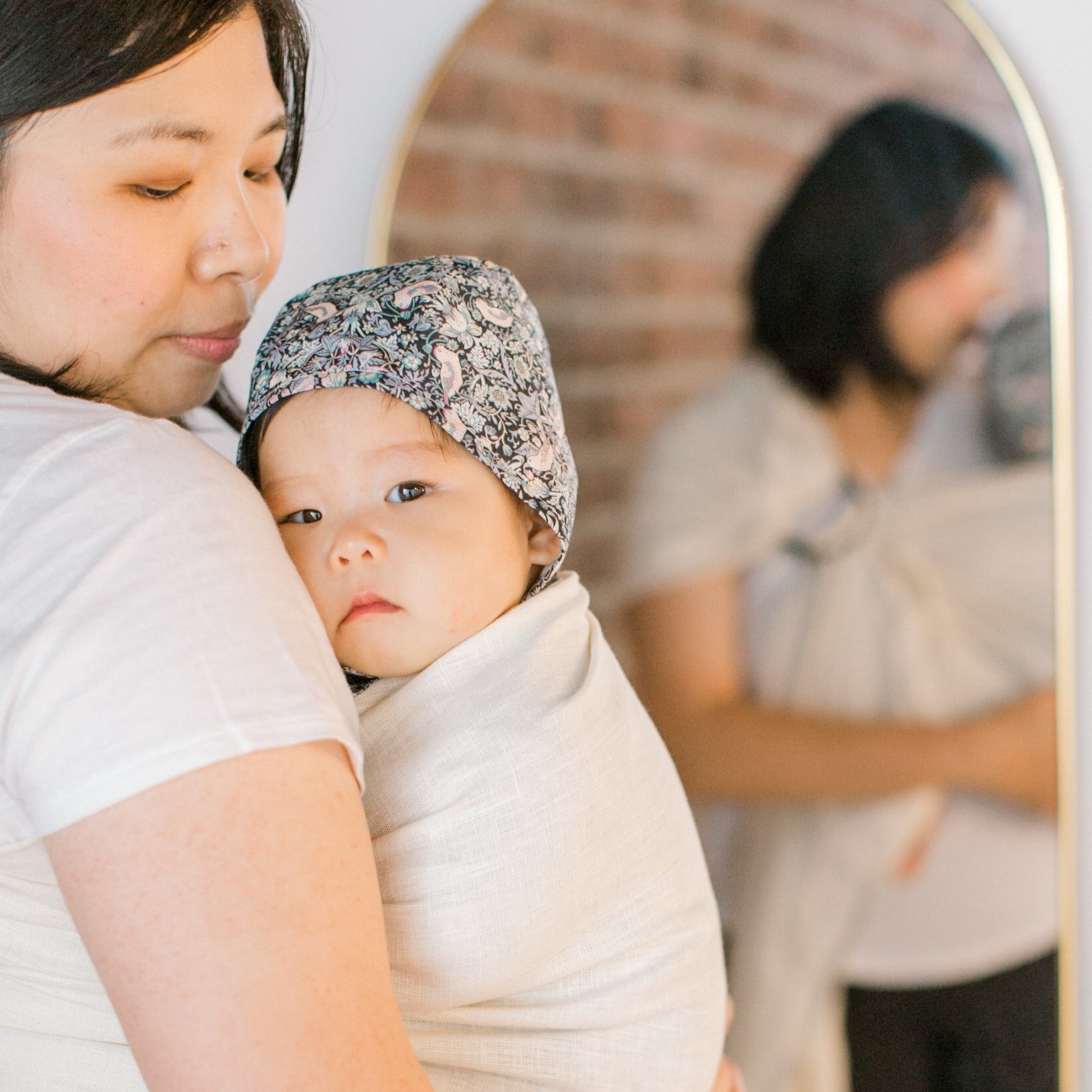 Hold Baby Close in White Linen Ring Sling